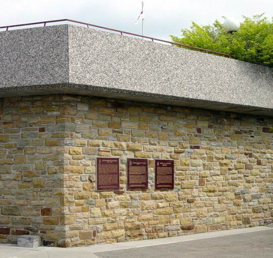 Three plaques on the Bell Museum wall