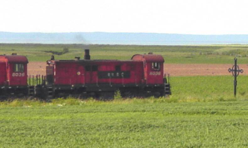 Eastbound freight train approaching the Iron Cross monument